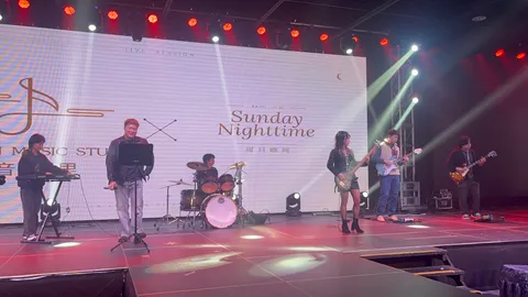 Six-piece student band performing on the showcase stage